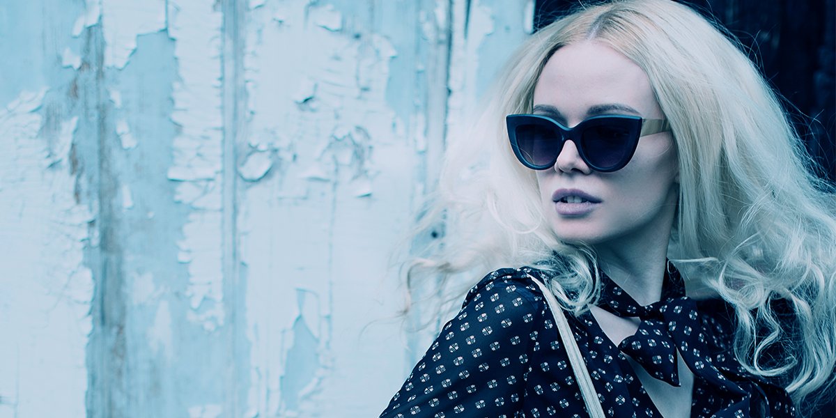 a blonde woman wearing sunglasses in the style of movie atomic blonde