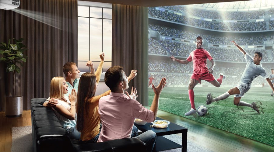 friends get together in a living room to enjoy football game playing on a projector