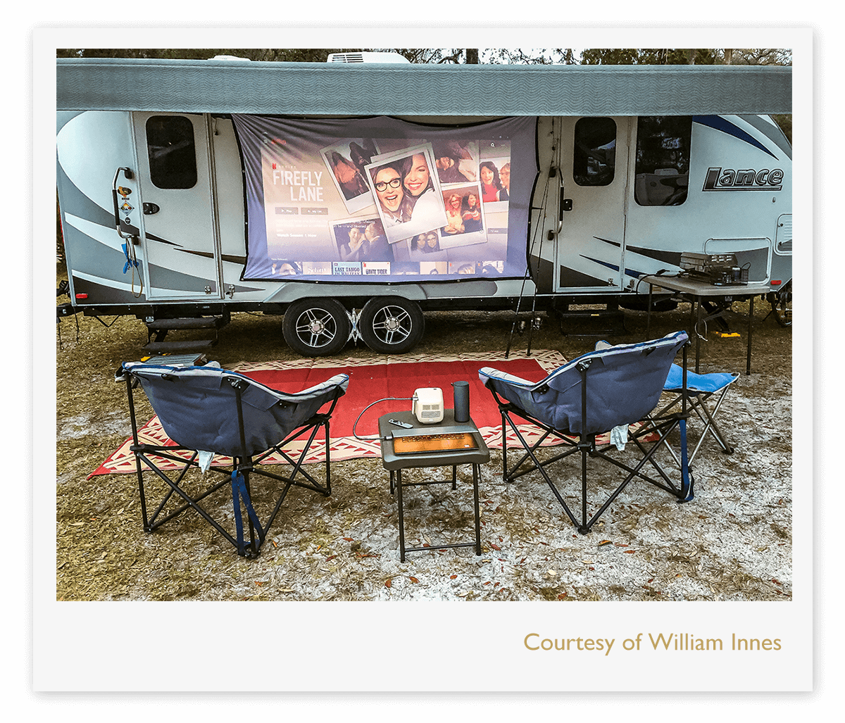 A portable projector displaying an image on the walls of a camper van